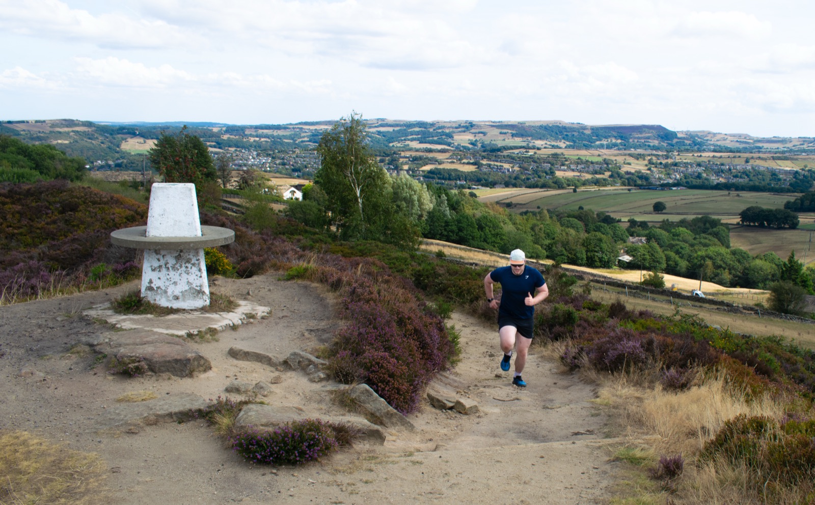 Shea running above a broad countryside valley